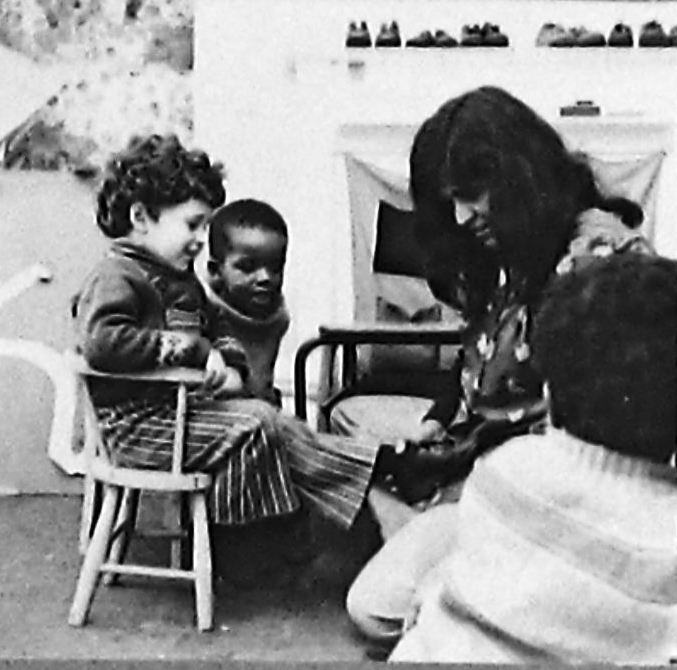 ‘Women and Work’ 1975 ©Hackney Flashers Image from ‘Women and Work’ 1975 shows a woman helping a child put on shoes.