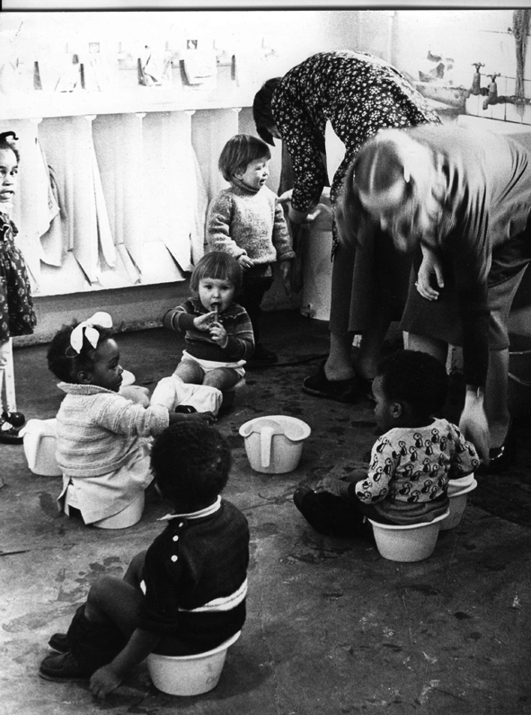 ‘Women and Work’ 1975 ©Hackney Flashers Image from ‘Women and Work’ 1975 shows women working in childcare lining up children to sit on potties.