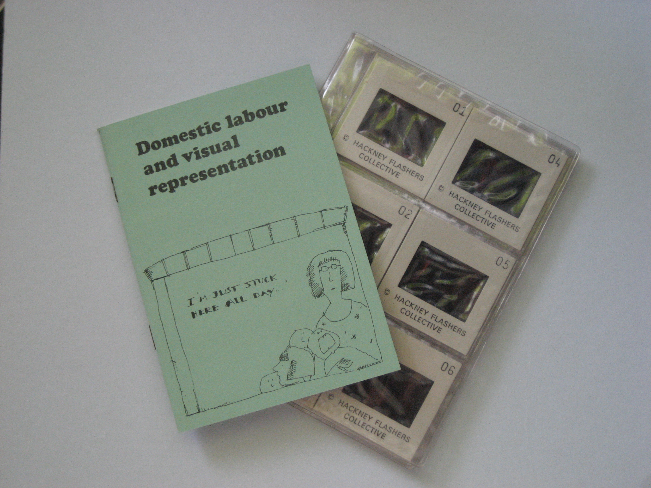 Domestic labour and visual representation slide pack. A booklet and a pack of numbered slides labelled Hackney Flashers Collective. The booklet cover reads "Domestic labout and visual representation".